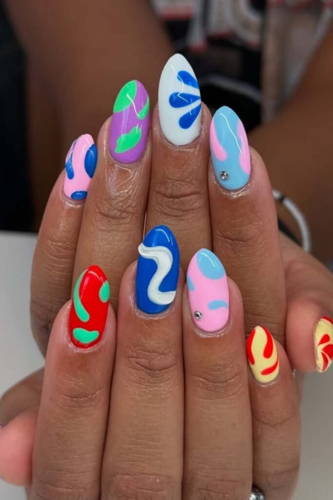 Neon swirl acrylic nails with wave patterns.