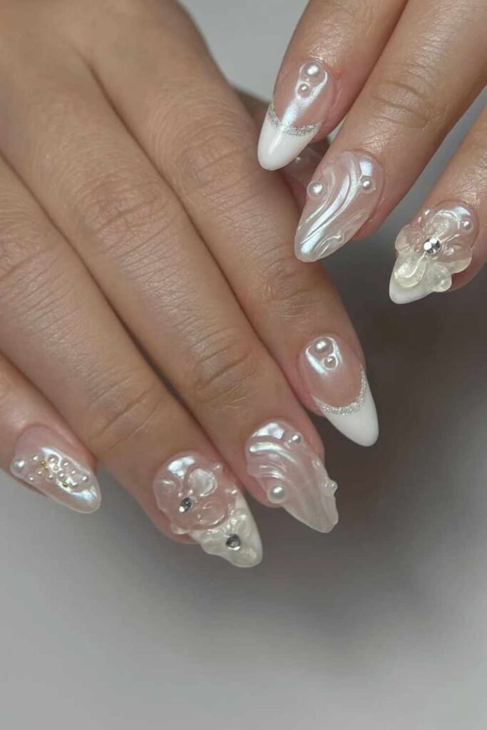 Bridal nails featuring sculpted 3D flowers and pearls for an ethereal and romantic floral design.