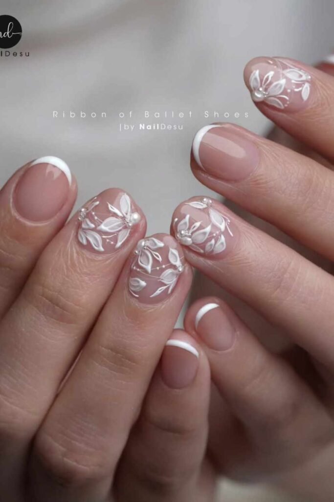 embroidery-style nail art in soft white on a neutral base, inspired by wedding gowns.
