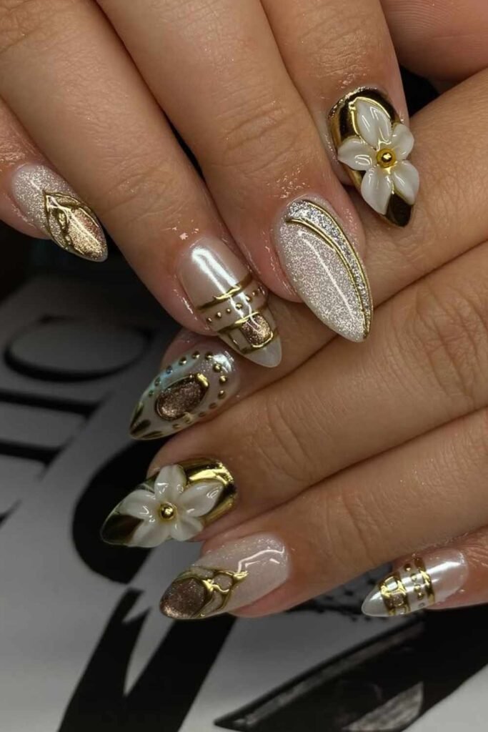Wedding nails with gold parttern and 3D sculpted floral details, perfect for brides wanting a luxe look.
