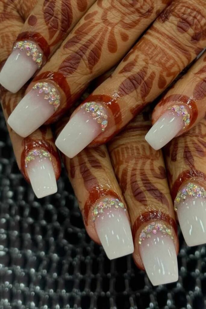 Soft ombre wedding nails in milky white shades with subtle pearl accents for understated bridal elegance.