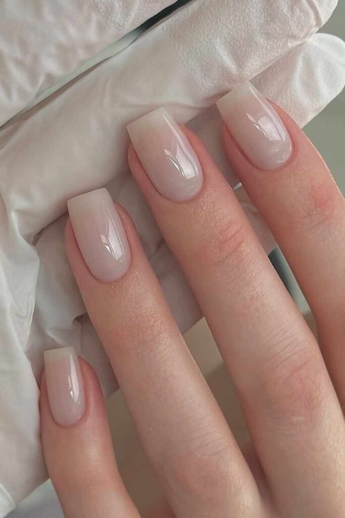Milky white wedding manicure for brides, minimal and clean design with soft natural finish.