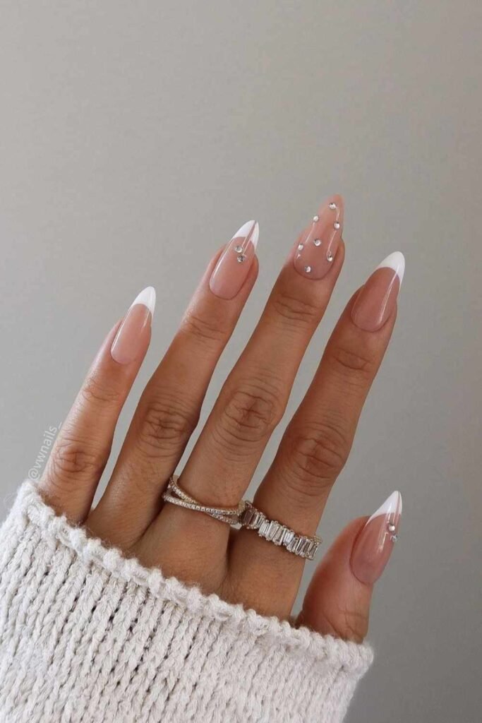Shiny pearl-toned tip mani, glowing with white chrome and classic bridal flair.