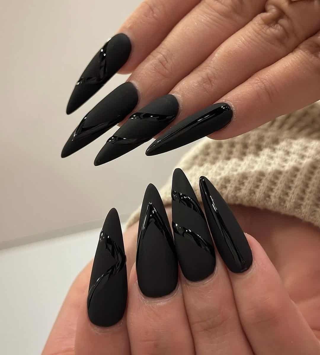 Nail design featuring a black matte base paired with 3D snake art feels daring and dramatic