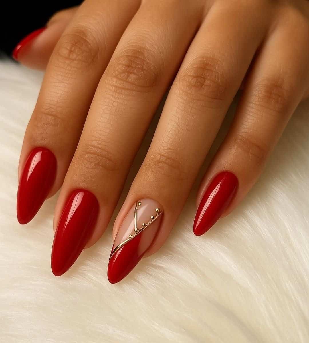 Image of Almond-shaped nails in a glossy red with a golden accent