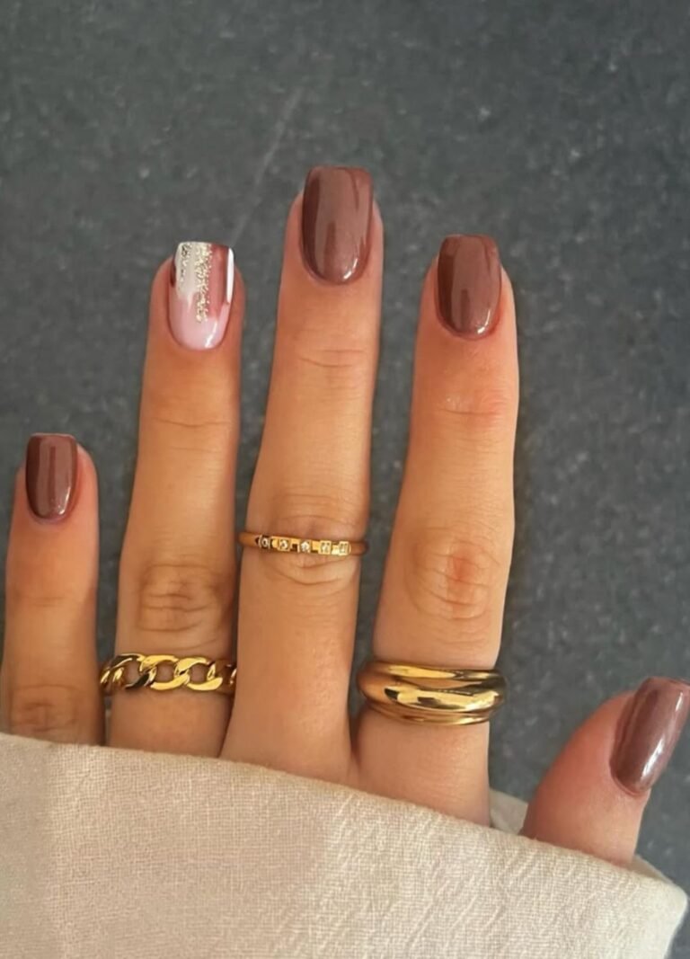 ladys nails featuring abstract patterns mixed with brown milky and golden foil on a single nail, paired with plain glossy browns
