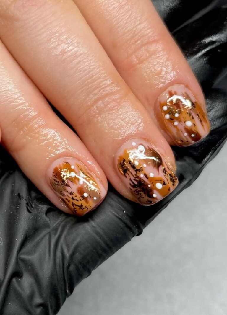 Minimal yet artistic, brown and golden dash-patterned accents with white dots on a nude base create a chic, abstract look.