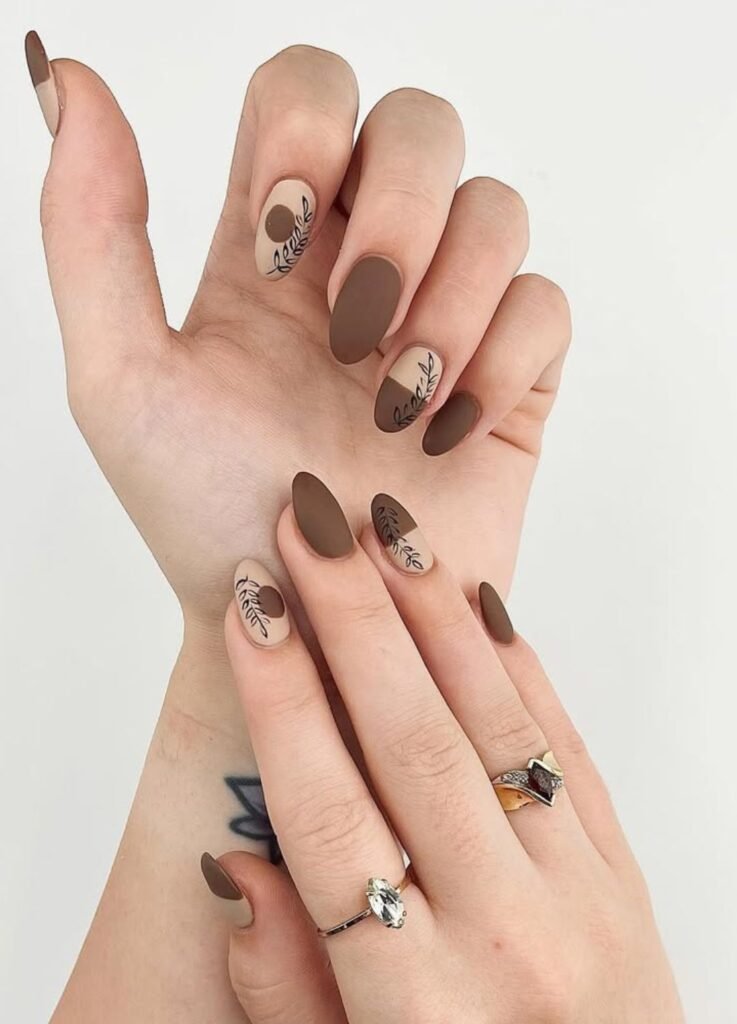 matte brown nails topped with intricate fall leaves. It’s warm, seasonal, and timeless.