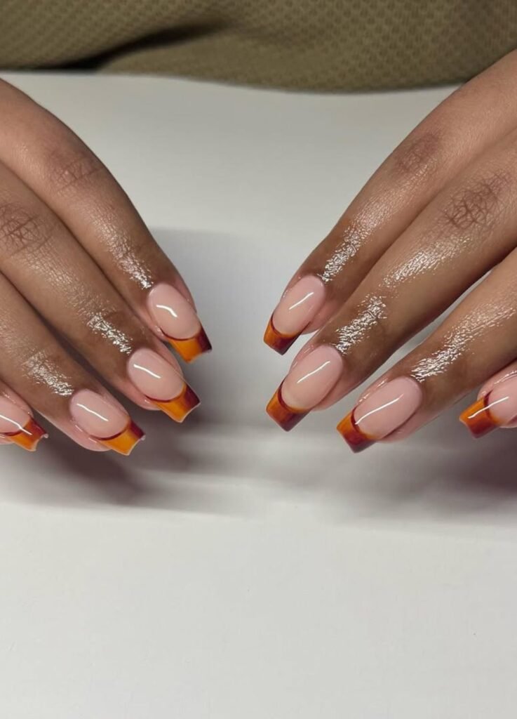 Nude base with brown French tips art gives the perfect subtle nod to fall.