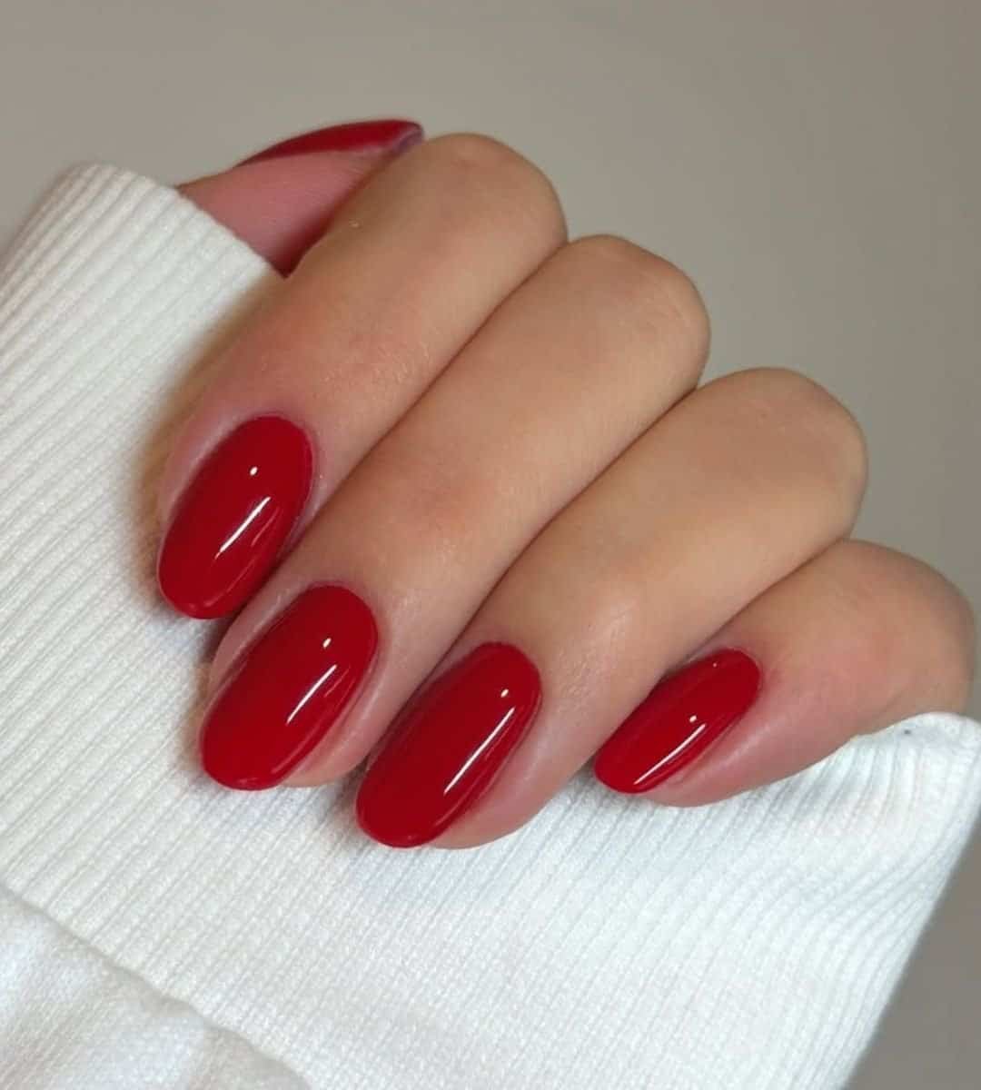 Image of Simple, glossy strawberry red gel nails are timeless.