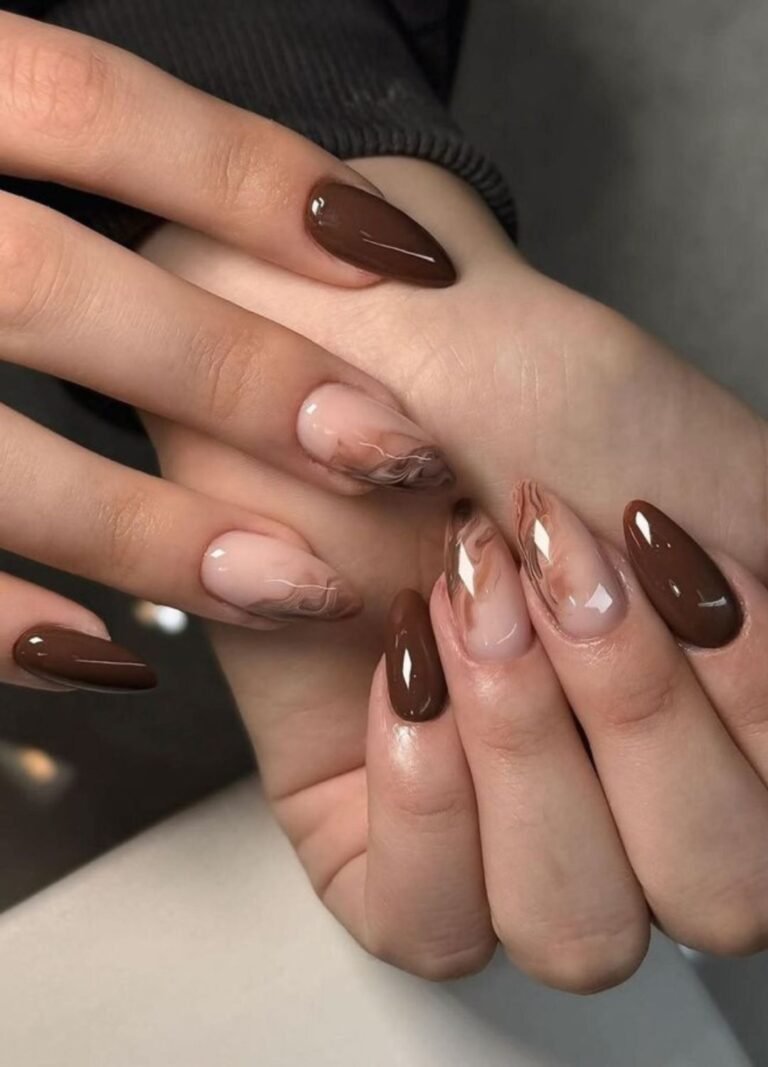 Nail art featuring chocolate flame nails on nude glossy marble accents paired with plain chocolate brings the drama.