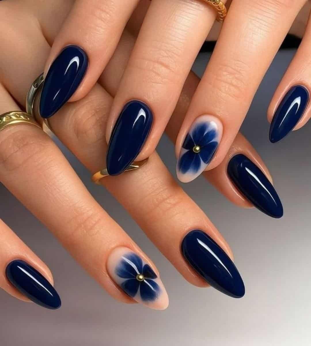 Deep Navy Nails & Soft, Hand-Painted Floral Accents. Deep blue floral on a nude base gives balance, strong yet delicate. 