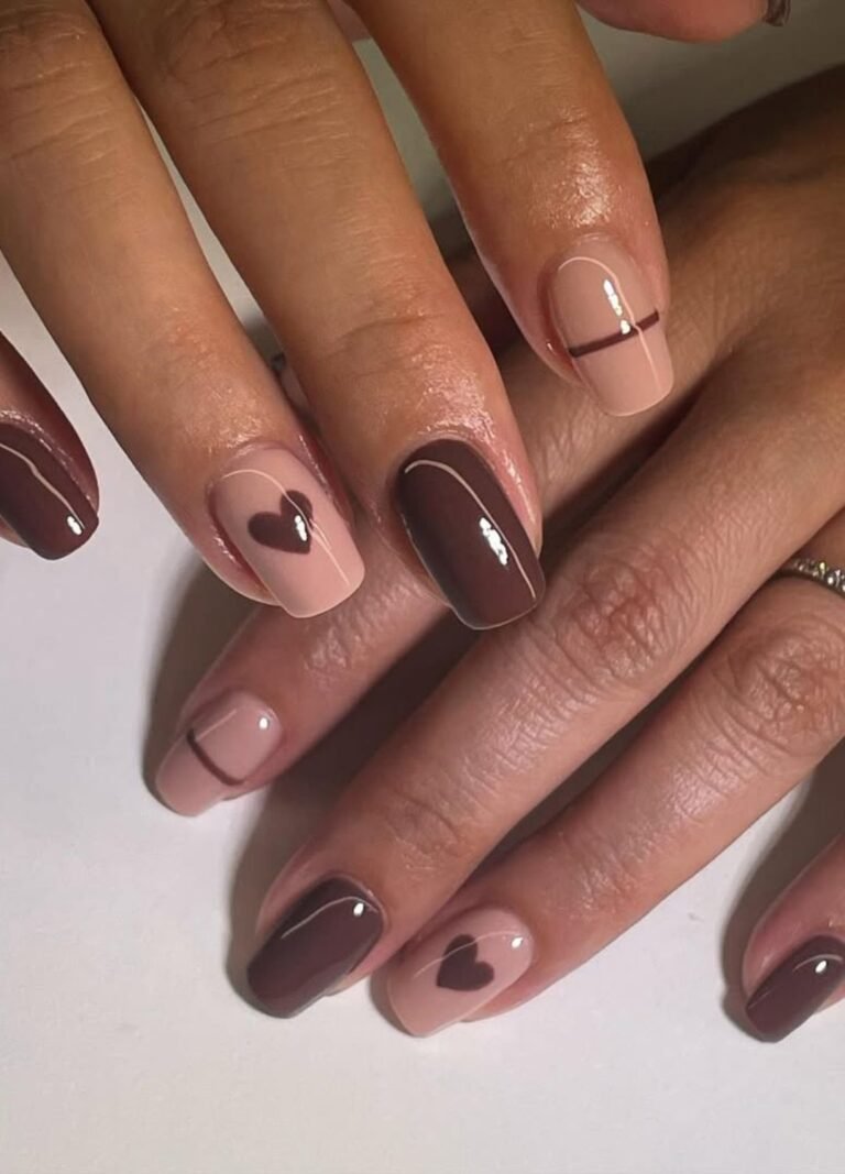 Heart accents on a nude base with rich chocolate brown all in one set of nails