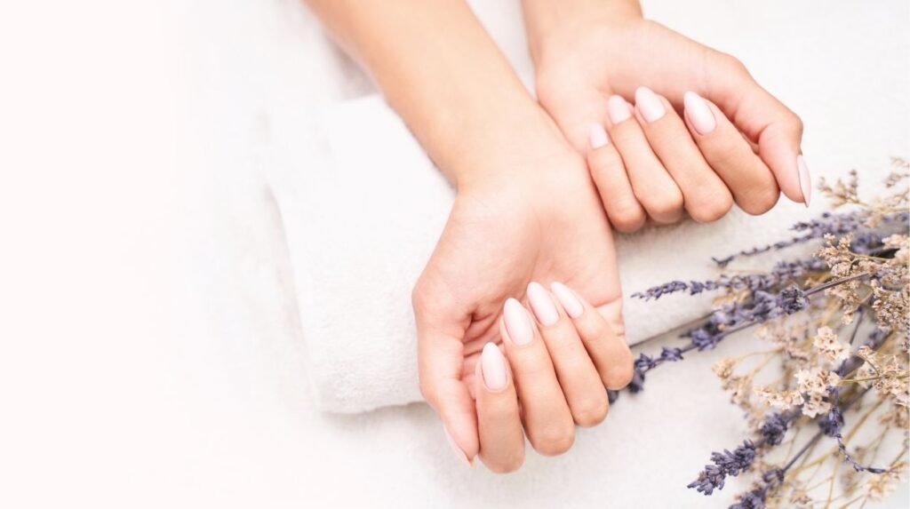 Close-up of glossy gel nails with a protective top coat, showing how to protect your gel nails from breaking and damage during everyday household chores.