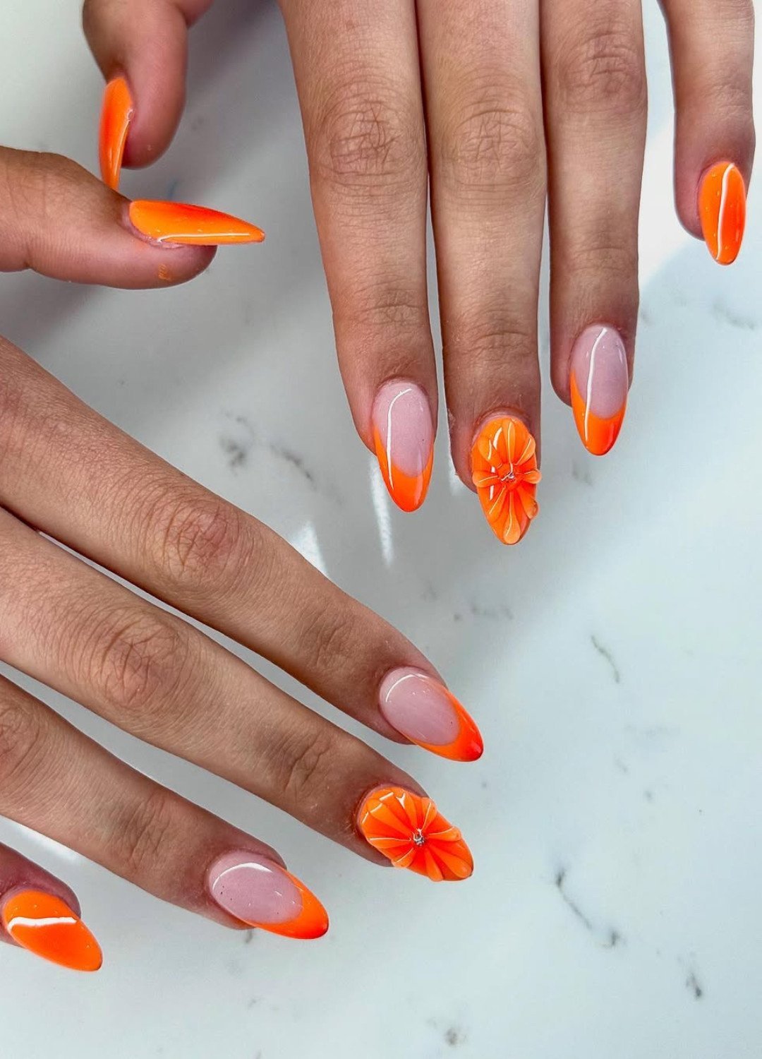 display of A twist on the timeless French manicure, this look swaps in orange tips, ombre and adds textured 3D floral details for extra flair. It’s chic, trendy, and definitely Instagram-worthy.