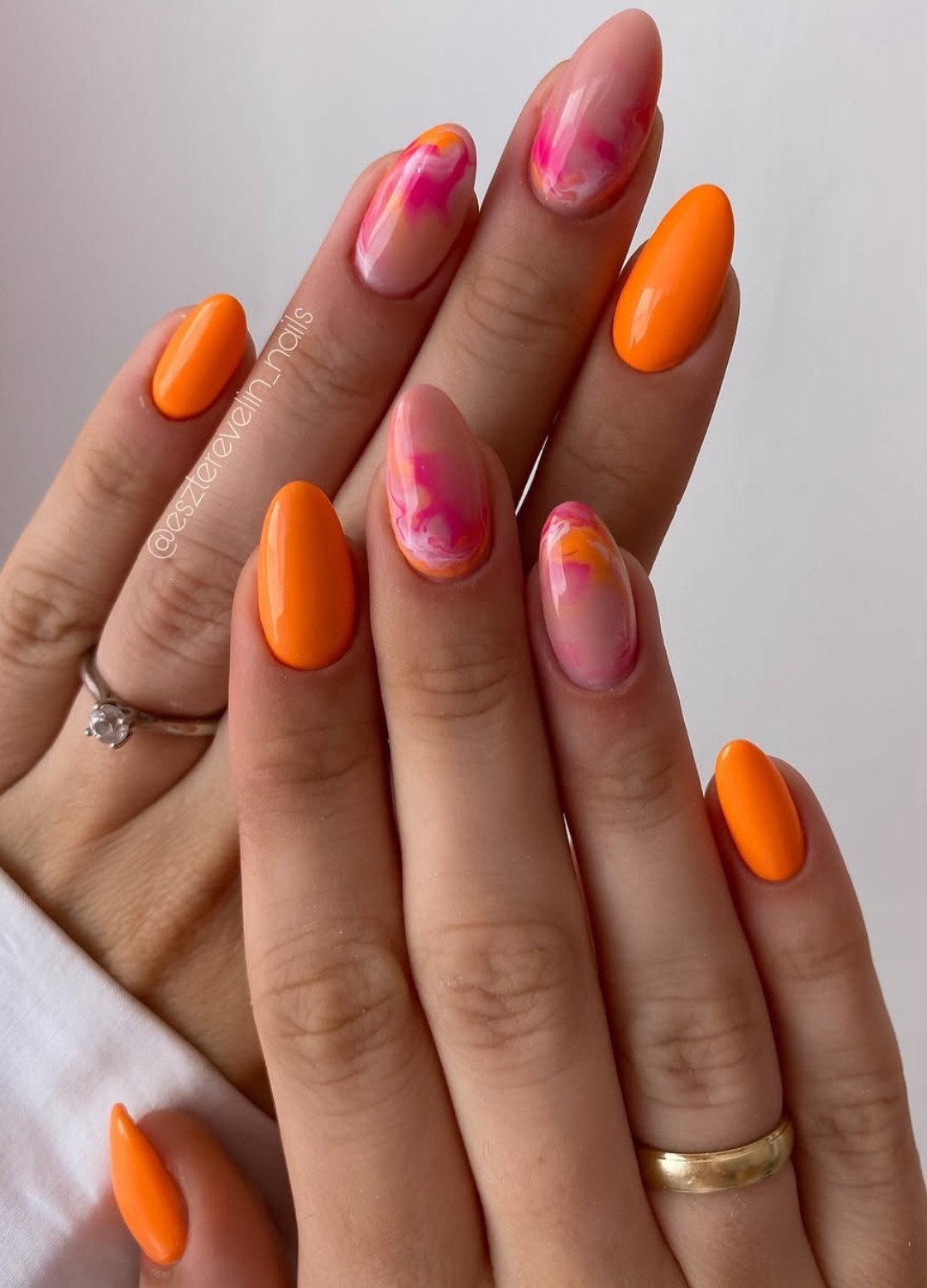 Display of Flame nails mixing pink and orange on a nude base to makes them even more vibrant.