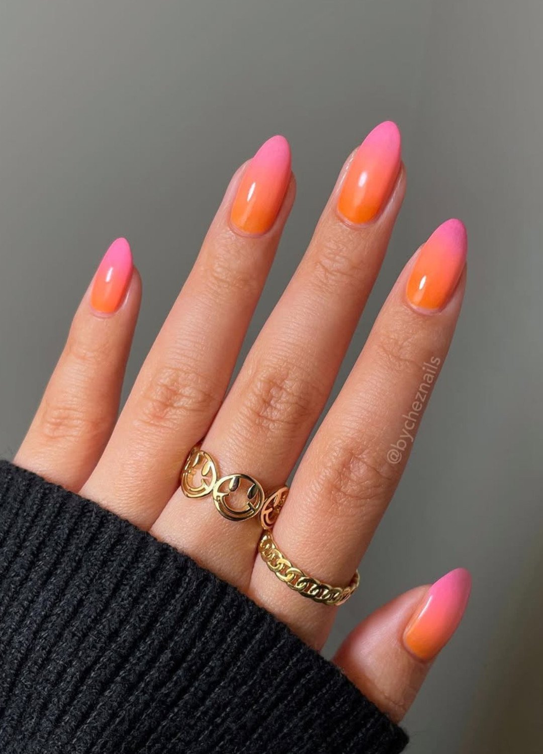 Display of Nail Design featuring soft gradient from pink to orange; it feels playful and romantic.