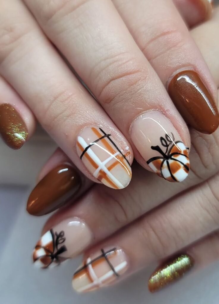 Image of Thanksgiving nails featuring brown chocolate, glitter, brown  and white pumpkin with plaid patterns  