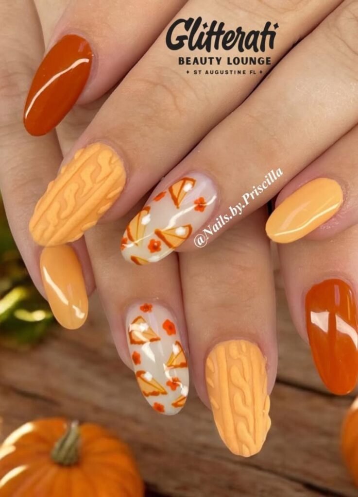 Thanksgiving nail ideas
This design layers playful pumpkin slice art over a warm nude or cloudy base on one finger, while the other carries an orange sweater, giving your nails a fresh twist on fall classics.